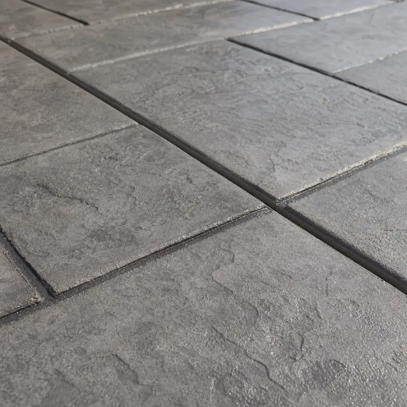 Stamped concrete patio with crisp pattern imprint, uniform color, and an integrated control joint